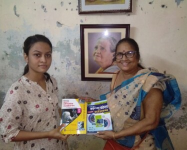 A well-wisher of the Foundation Mrs. Rubi Lahiri handing over few books to beneficiary Sreejoyee Roy.