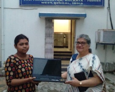 One of our valued donors Mrs. Tapati Barman handing over a donated laptop to beneficiary Dipanwita Ghosh.