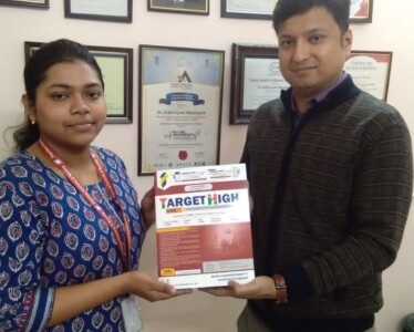 Prof ( Dr) Subhrojyoti Bhowmick of The Peerless Institute of Nursing handing over a book to Miss. Dipanwita Ghosh