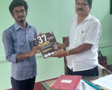 - Head Sir of Kokond Kalika Siksha Sadan, Goghat, Hooghly Shri. Gautam Karak handing over a book to student Debnath Ghosh.